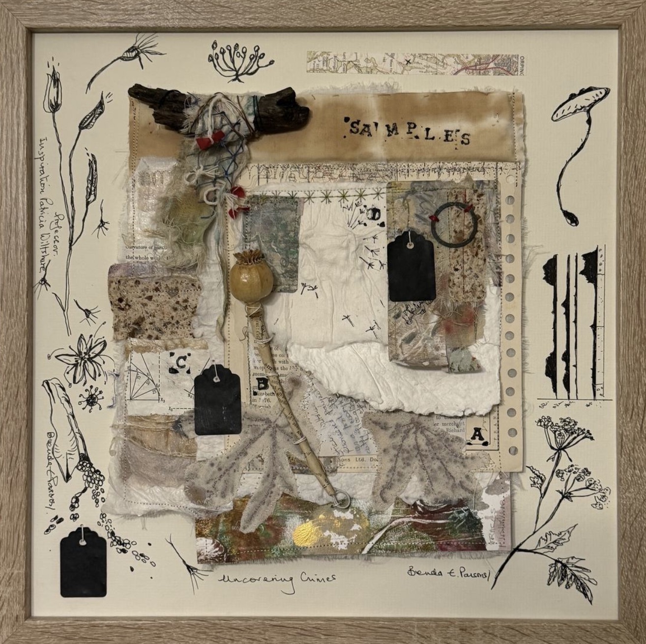 Framed mixed media collage with found papers, tags, maps and botanical drawings